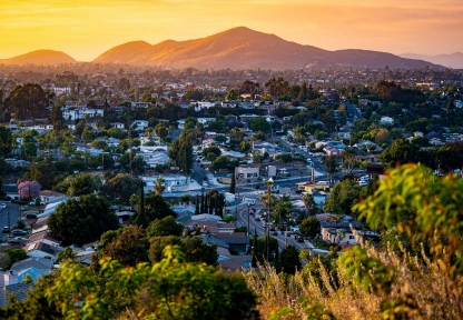 Panoramic view of La Mesa, California showing residential areas and hills at sunset.